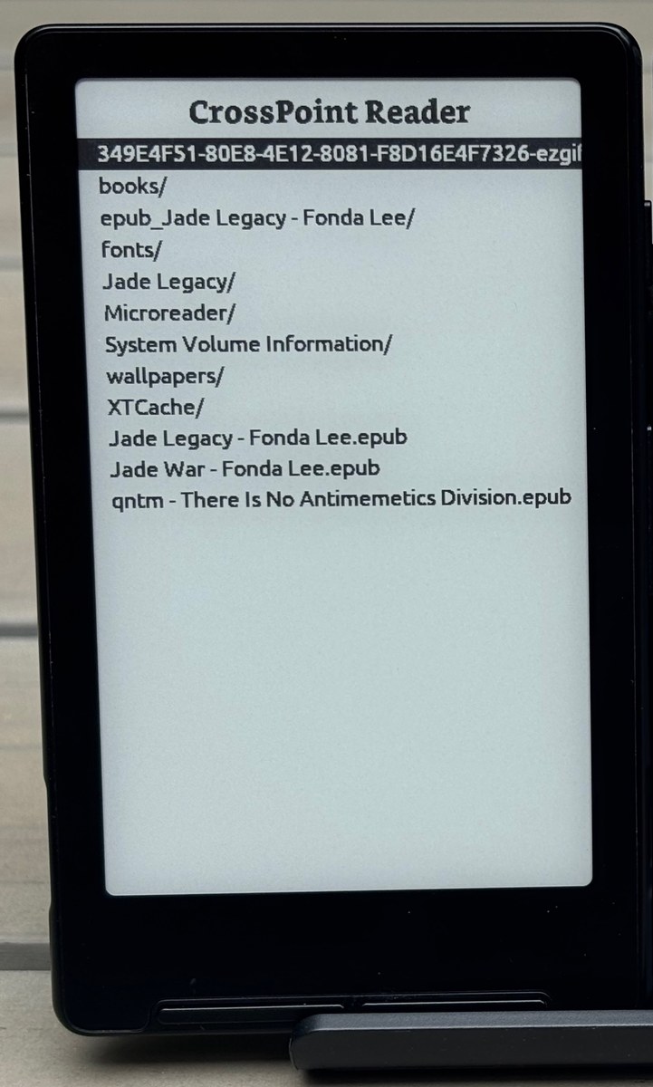 An Xteink X4 e-reader showing the CrossPoint menu.